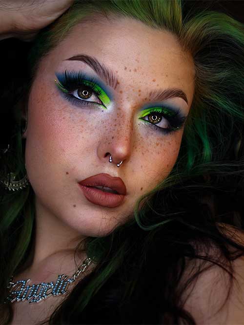Blue and neon green eyeshadow look with overlined lips for spring 2023