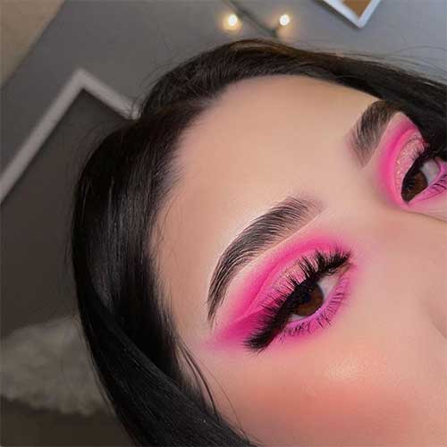 Fluorescent pink eyeshadow look with glitter and false lashes