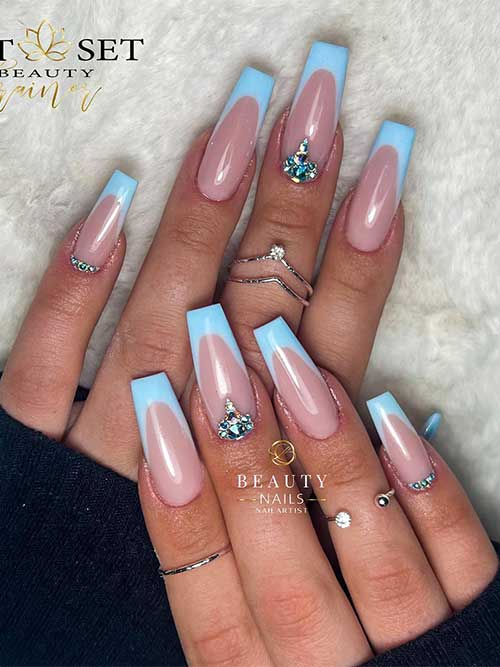 Long coffin light blue French tip nails with rhinestones on two accent nails