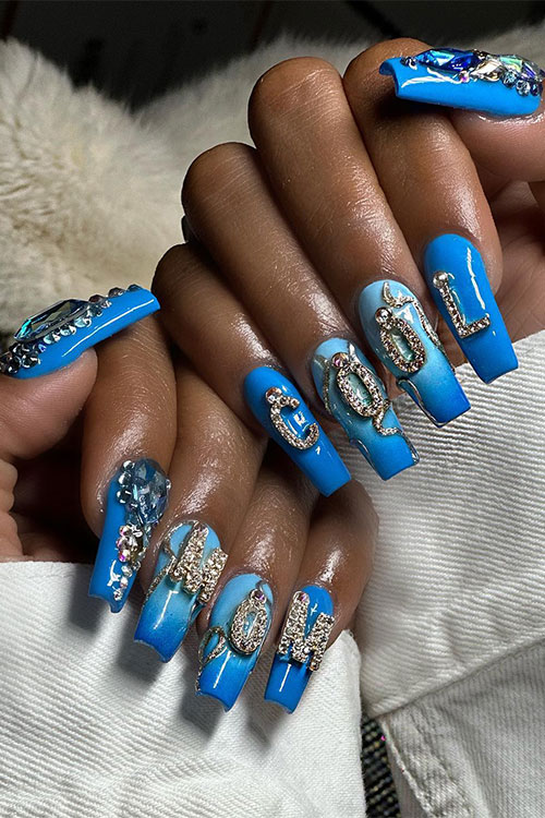 Long coffin royal blue mothers day nails adorned with rhinestones and glued rhinestone “COOL MOM” letters on the nails