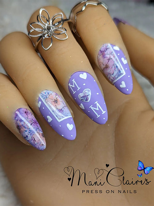 Matte light purple Mother’s Day press on nails with floral nail art, white hearts, white dots, and MOM letters