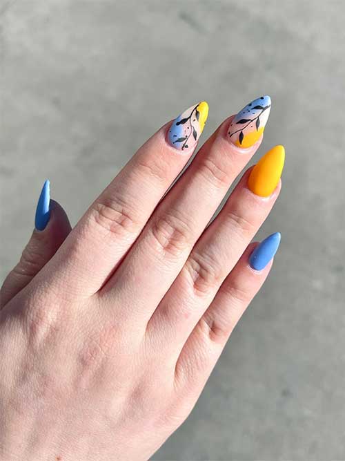 Medium almond blue and yellow nails with botanical nail art for spring 2023