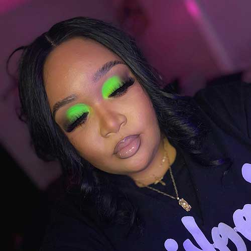 Neon green eyeshadow with nude lips for black girls