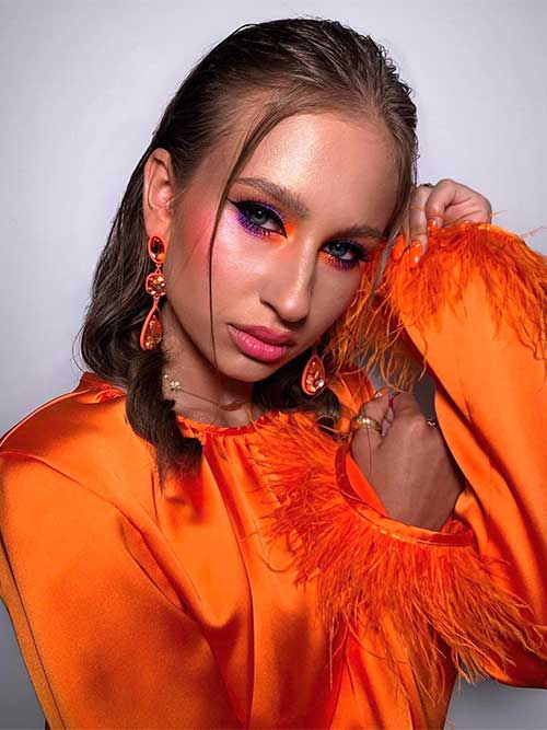 Neon makeup look using neon purple eyeshadow and neon orange eyeshadow on the eye corners