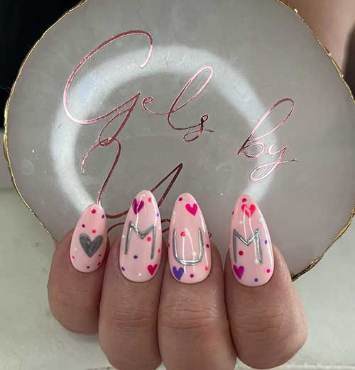 Pastel pink mom nails with heart shapes, dots, and silver MUM letters 