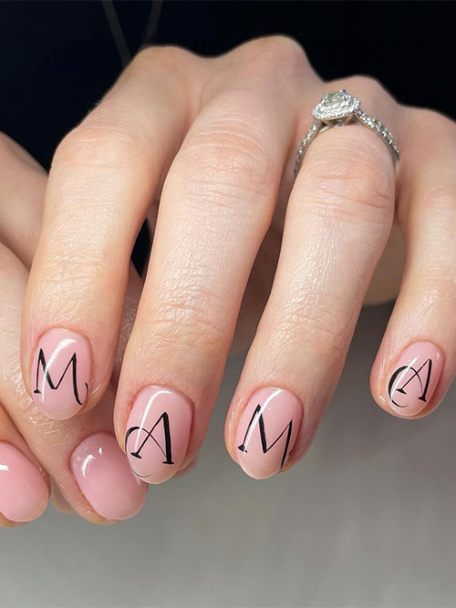 Simple nude short Mother’s Day nails with “MAMA” black letters
