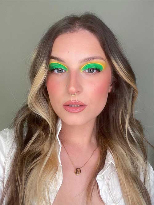 The neon green eyeshadow paired with neon eyeliner is a bold and daring look that is sure to turn heads!