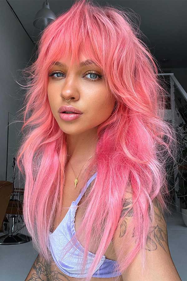 A long pink shag haircut with black hair roots is one of the edgy shag hairstyles