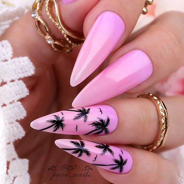 Long almond shaped pink ombre summer nails with black palm trees on two accent nails