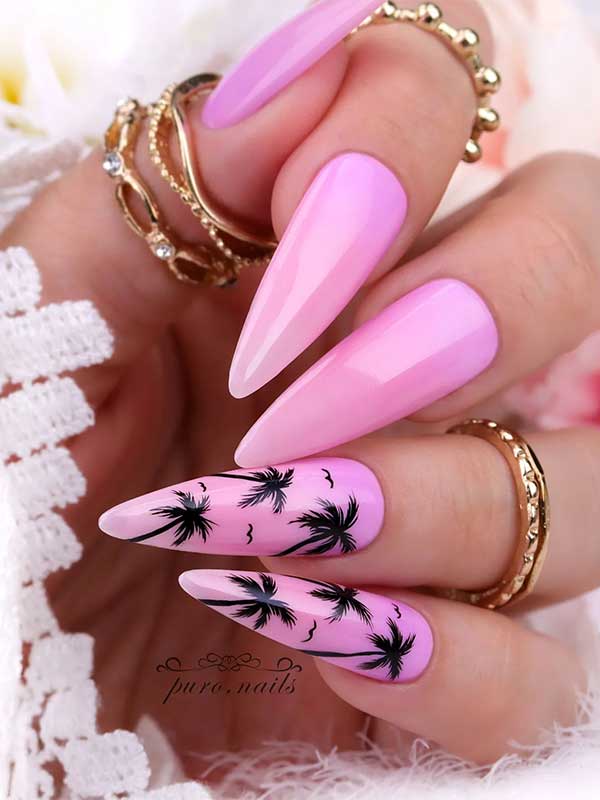 Long almond-shaped pink ombre nails with black palm trees on two accent nails