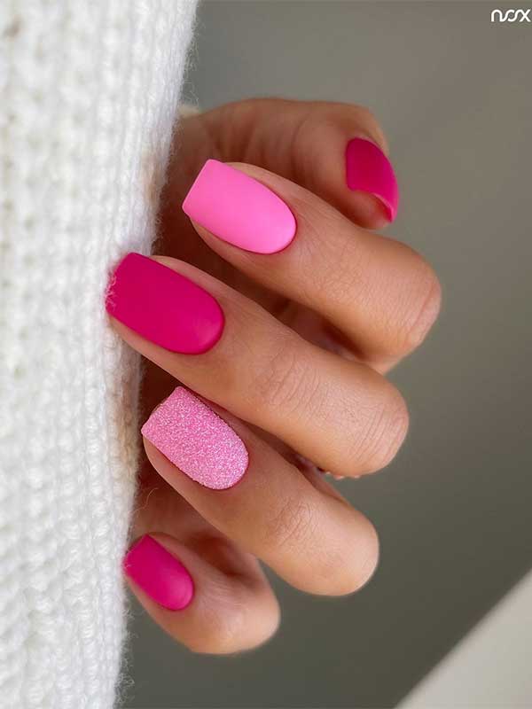 Short matte light and hot pink nails with glitter on an accent light pink nail