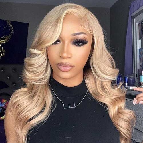 Long hair dyed in Honey Blonde hair color that is one of the best fall hair colors for 2023