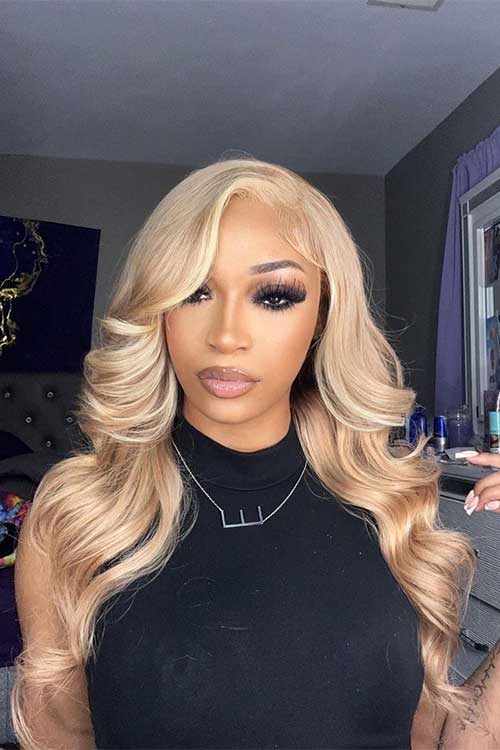 Long hair dyed in Honey Blonde hair color that is one of the best fall hair colors for 2023