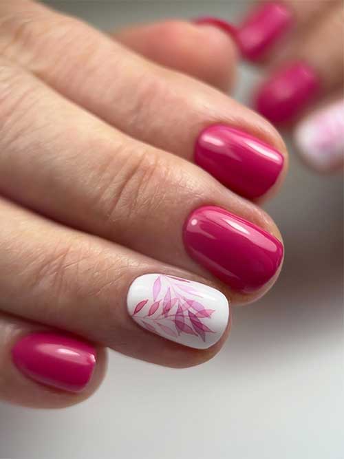 Simple short pink nails with pink tropical leaf nail art on an accent white base nail
