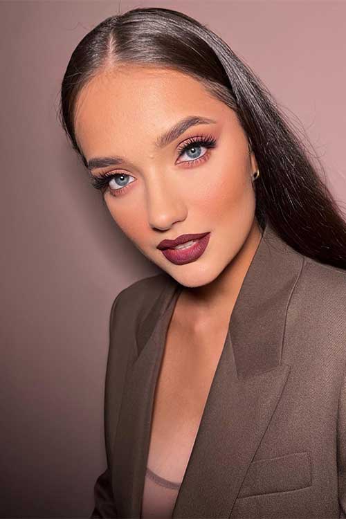 Bordeaux makeup look with rich burgundy lip color and soft and neutral eyes with taupe and brown shades