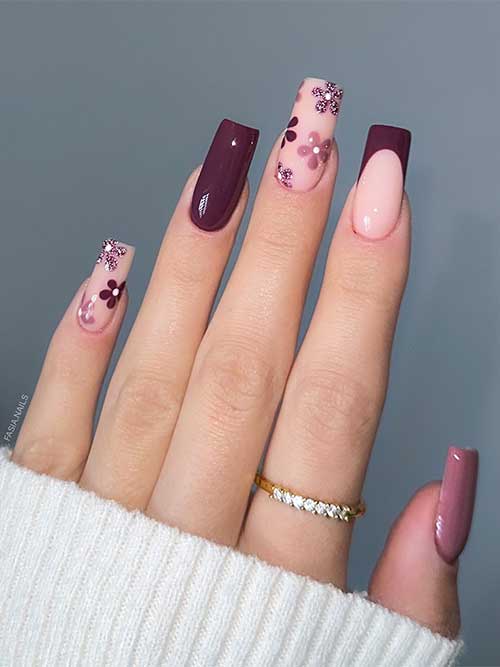 Chic brown and nude rose nails embellished with floral nail art and glitter flowers, perfect for a fashionable appearance.