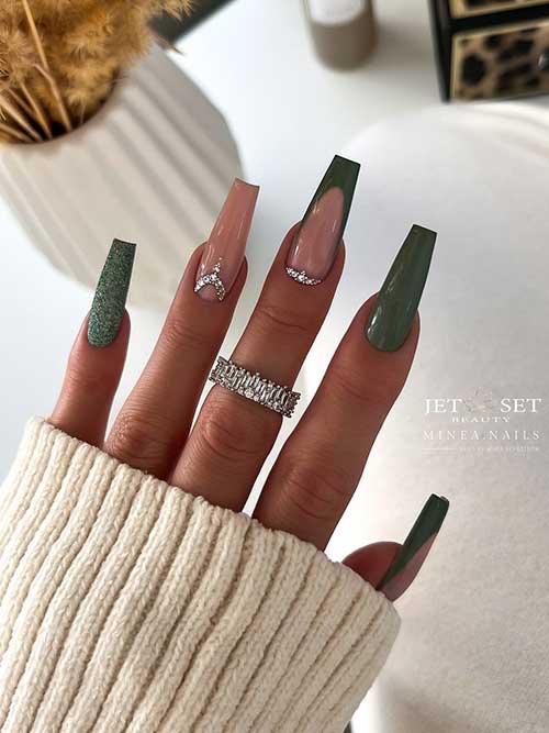 Dusty dark green coffin-shaped nails featuring French tips, a nude accent, and a glittery dark green design.