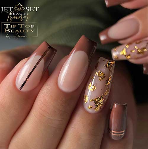 Light brown September nails featuring French tips, gold strips, and a nude pink nail adorned with gold foil accents.