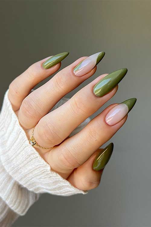 Long almond-shaped deep green September nails and swirl nail art on two eye-catching accent nails