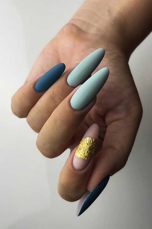 Long almond-shaped matte mint and blue nails and nude accent adorned with gold foil patch