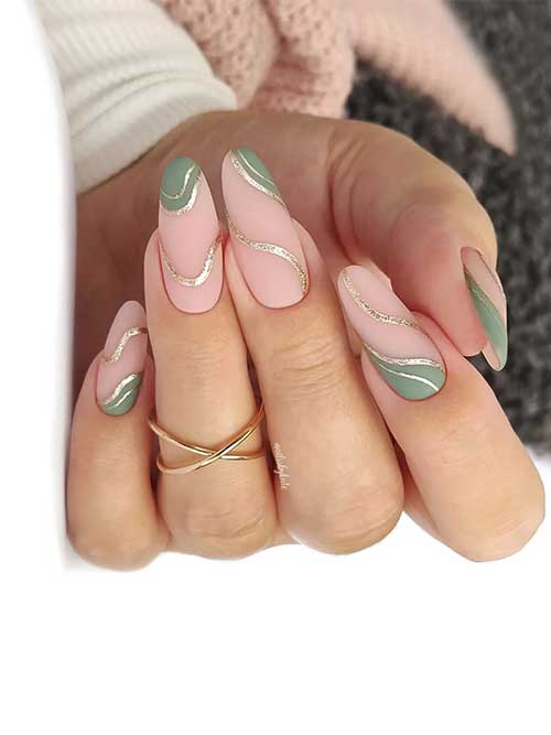 Matte cream sage green almond-shaped nails with gold glitter swirls over a nude pink base.