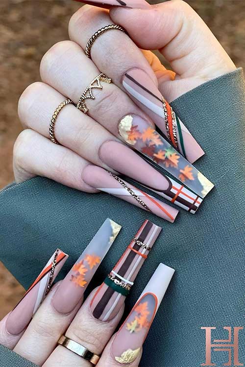 Matte long fall nails featuring autumn leaves, stunning plaid nail art, and glitter lines