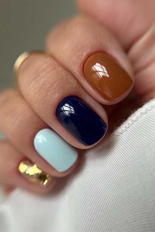 Short classy fall nails feature navy, light blue, light brown, and gold flakes foil nails.