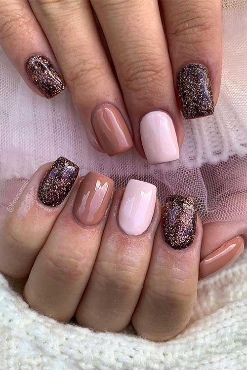 Short dark brown nails with glitter, light brown nails, and an elegant accent pink nail