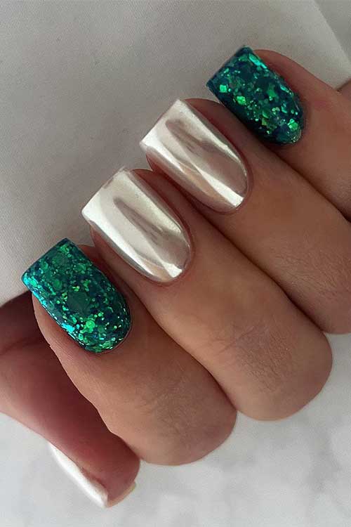 Short gold chrome nails and mesmerizing emerald glitter accent nails