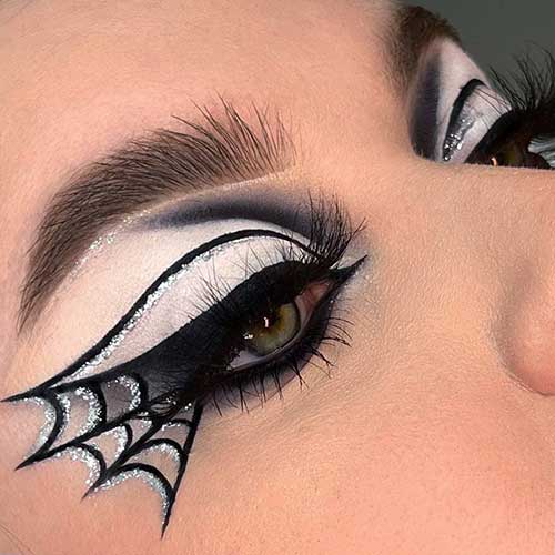 Black and silver glitter spider eyeliner makeup for Halloween.