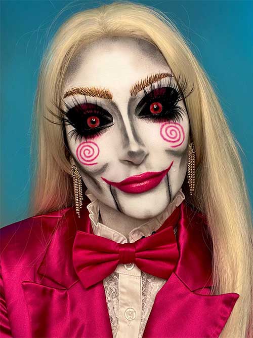 Creative Billy the puppet makeup black eyeshadow, red contact eyes, extra-long eyelashes, and a red swirl on each cheek