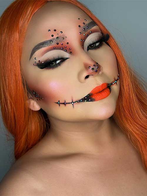 Creative pumpkin makeup with brown makeup on cheekbones, above upper eyelids and eyebrows and orange-red lips