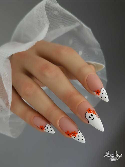 Cute white French Halloween nails with white tips, black dots, orange flowers, and an accent ghost design.