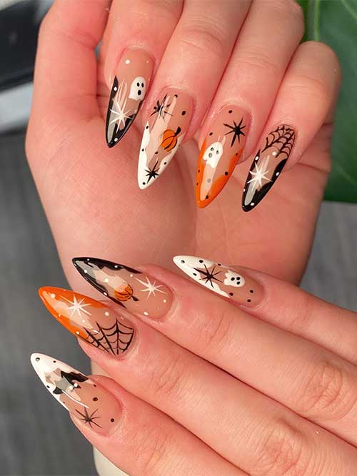 Halloween-themed nails in white, black, and orange featuring pumpkins, bats, cobwebs, ghosts, dots, and stars.