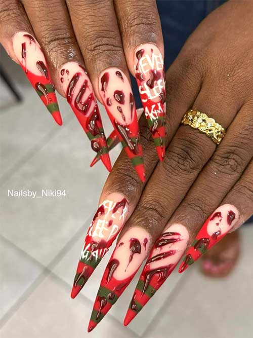 Long stiletto-shaped Halloween nails inspired by Freddy Krueger, adorned with bloody nail art for a spooky effect.