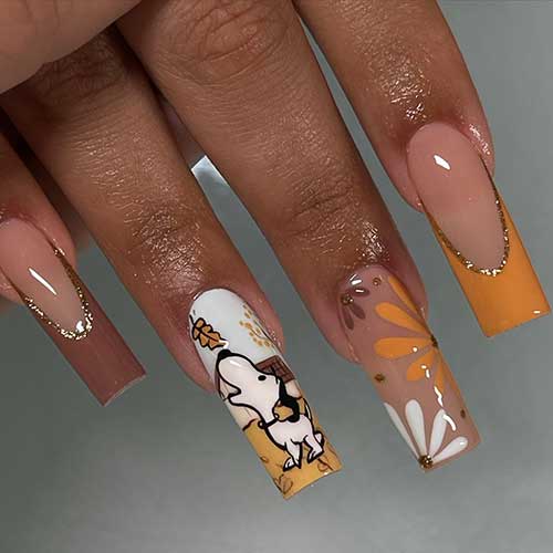 Brown and burnt yellow French Thanksgiving nails with gold glitter nude accents with flowers and snoopy with fall leaves