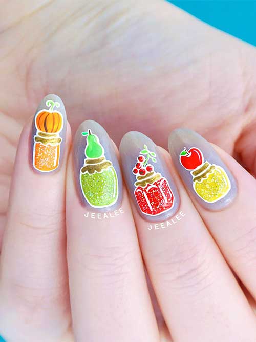Fruit Thanksgiving nails feature apple, cranberry, pear, and pumpkin and each corresponding fruit is on top of a jar lid