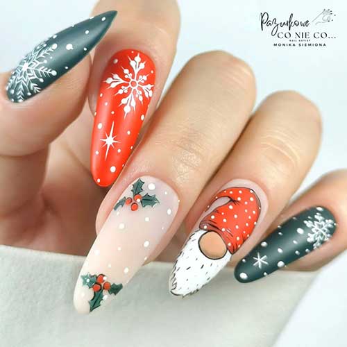 Long almond-shaped red and green Christmas nails with white snowflakes and a nude accent nail adorned with gnome nail art