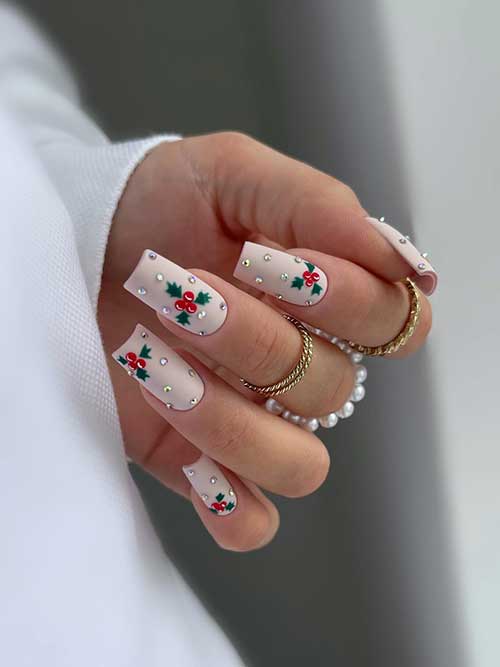 Matte nude Christmas nails with holly nail art and rhinestones