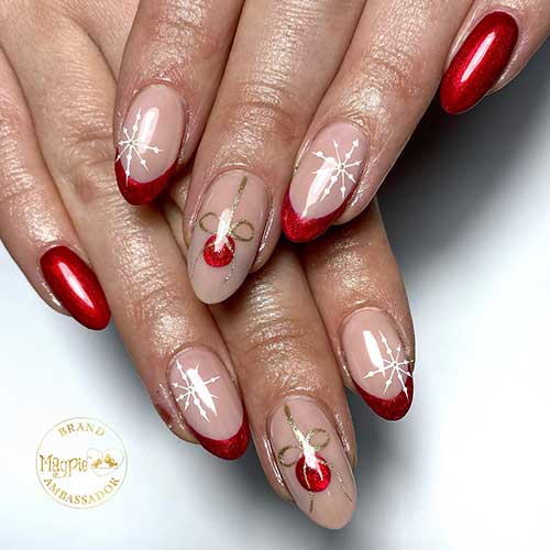 Medium almond shimmer red Christmas nails with two accent red French tips adorned with a white snowflake and a gift ball