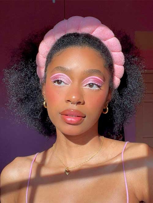 Beautiful pink Valentine’s makeup look using shiny pink eyeshadow, graphical liner at the socket line, and nude pink lips
