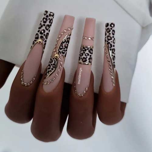 Creative long leopard nails feature long square-shaped matte French accents adorned with gold rhinestone decorations
