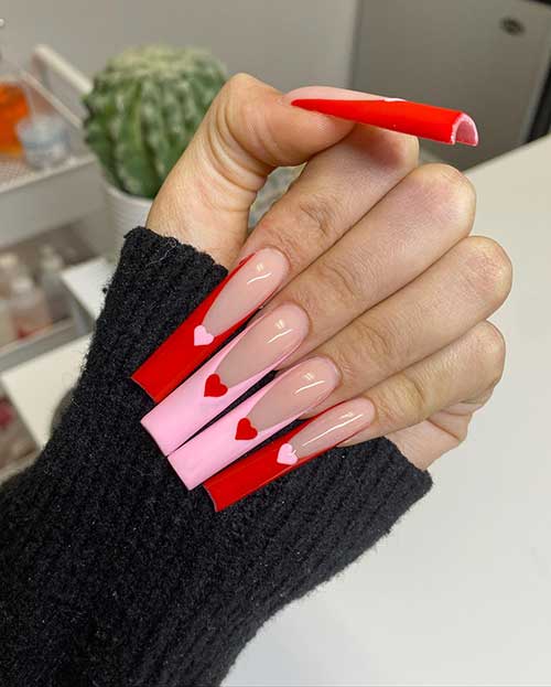 Long square-shaped red and pink French Valentine’s Day nails with a heart shape on each nail tip