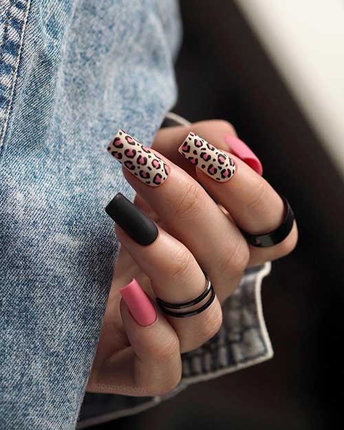 Medium square-shaped matte pink and black nails. With black and pink leopard prints over two accent white nails