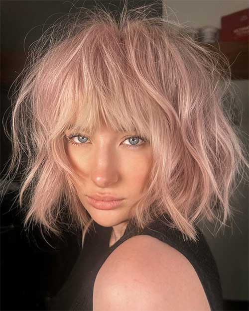 Pink short shaggy bob haircut with wavy textured hair