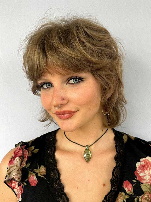 Wavy brunette shaggy pixie with curtain bangs