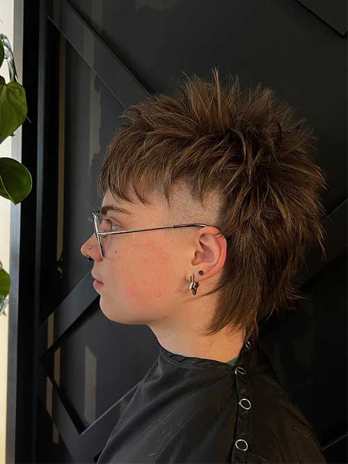 short shaggy mullet mohawk in brown hair with little blonde highlights