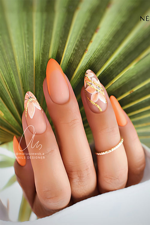 Almond-shaped orange spring nails with white and orange flowers on two accent nude nails with an accent French orange nail