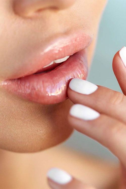 Keeping your lips protected by applying a lip balm throughout the day is one of the most important winter skin care tips