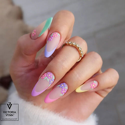 Long almond-shaped matte pastel multi-color French nails adorned with flowers are one of the best spring nail ideas 2024